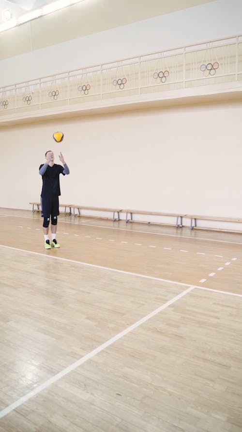 Volleyball Player Tossing and Spiking the Ball
