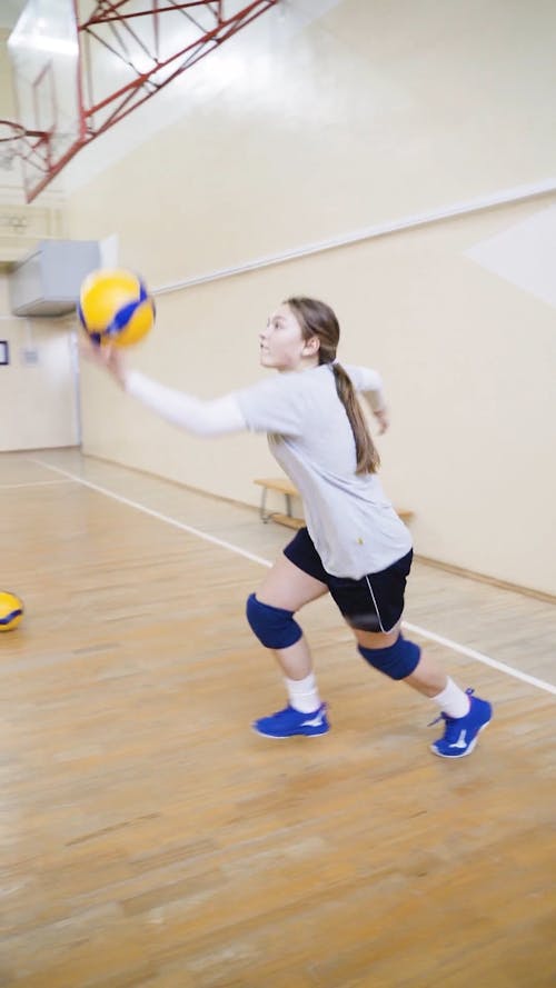 Volleyball Players Practice Serving