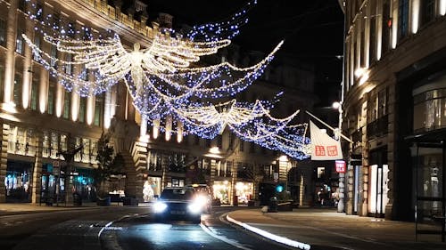 Traffic In Street Decorated With Christmas Lights