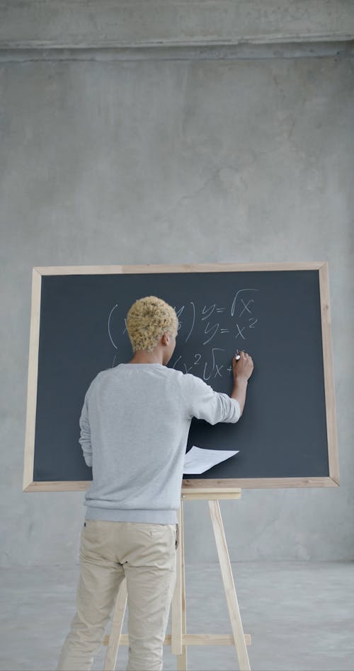 Student writting on a Blackboard