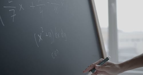 Person Writing on the Blackboard