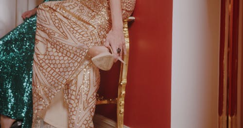 Glamorous Women Sitting on Chair and Fixing their Stilettos