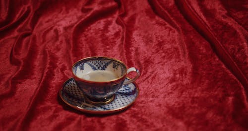 A Tea Cup on a Velvet Bed Linen
