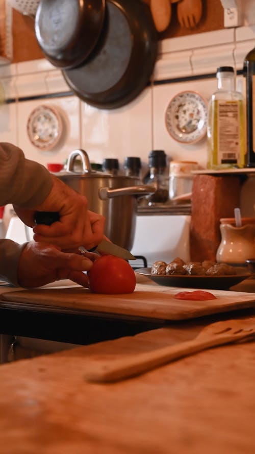 Person Cutting Tomato