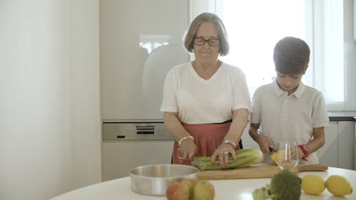 Grandmother and Grandson Cooking Together 
