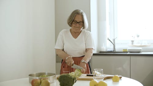 Elderly Woman Chopping Celery 