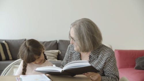 Grandma Reading Book With Chil