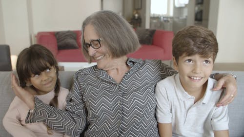 Grandmother with Grandchildren on the Sofa
