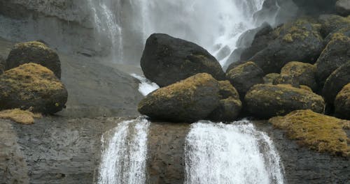 Waterfall and River Flowing on Mossy Rocks