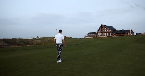 Golf Player Walking In The Field