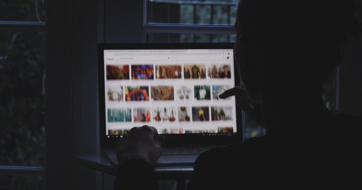 woman scrolling on computer screen 6258096