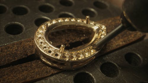 Person Making a Hole on a Jewelry