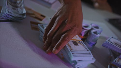 A Person Counting Cash Using a Calculator