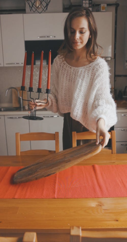 A Woman Arranging the Dining Table