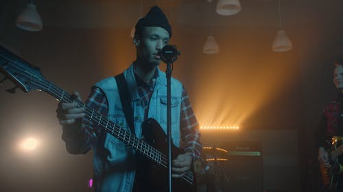 Man Palying the Bass and Singing in a Band 