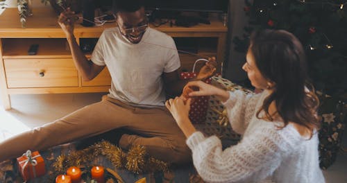 Man and Woman Having Fun During Christmas Decoration