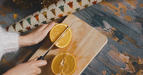 Overhead Shot of a Person Slicing an Orange
