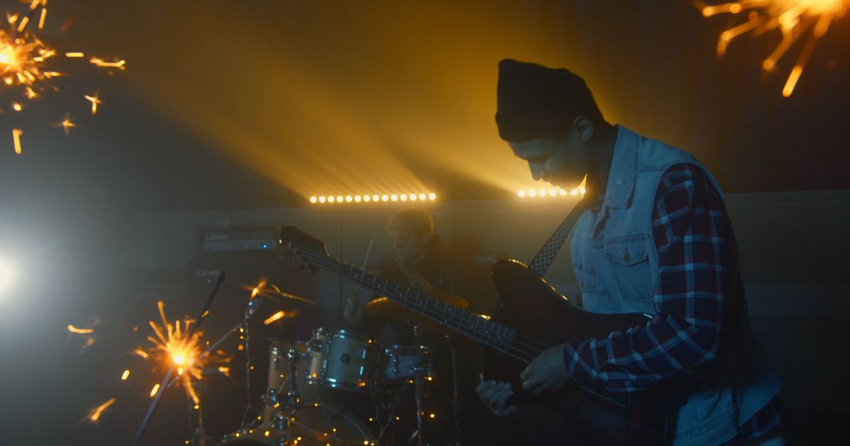 Nightform official video still — band on a dark stage