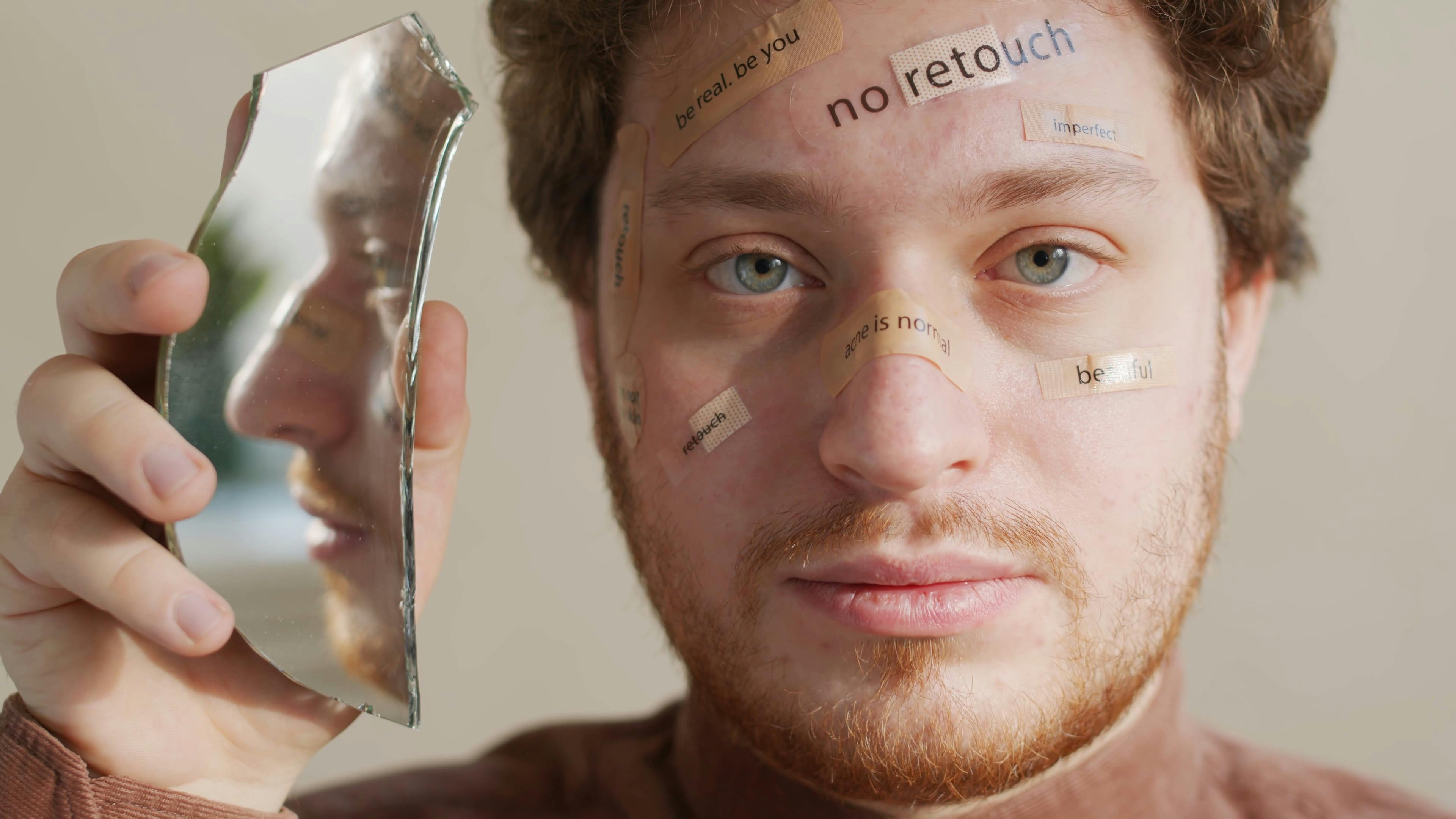 Young Man Holding a Piece of Mirror and Looking at Camera ...