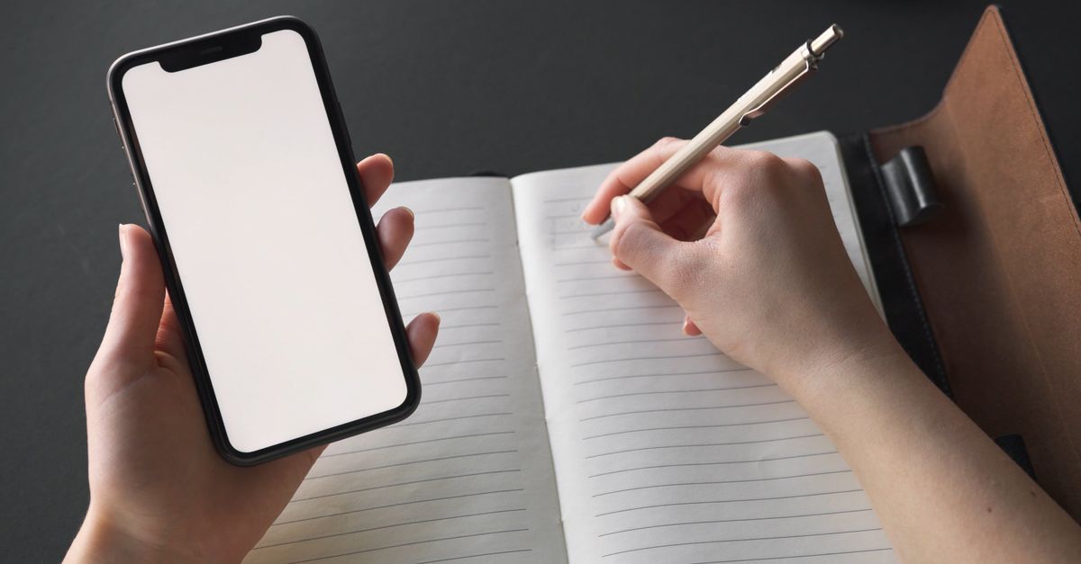 Writing Note On Phone Person Holding Mobile Phone While Write On Notebook Free Stock Video ...