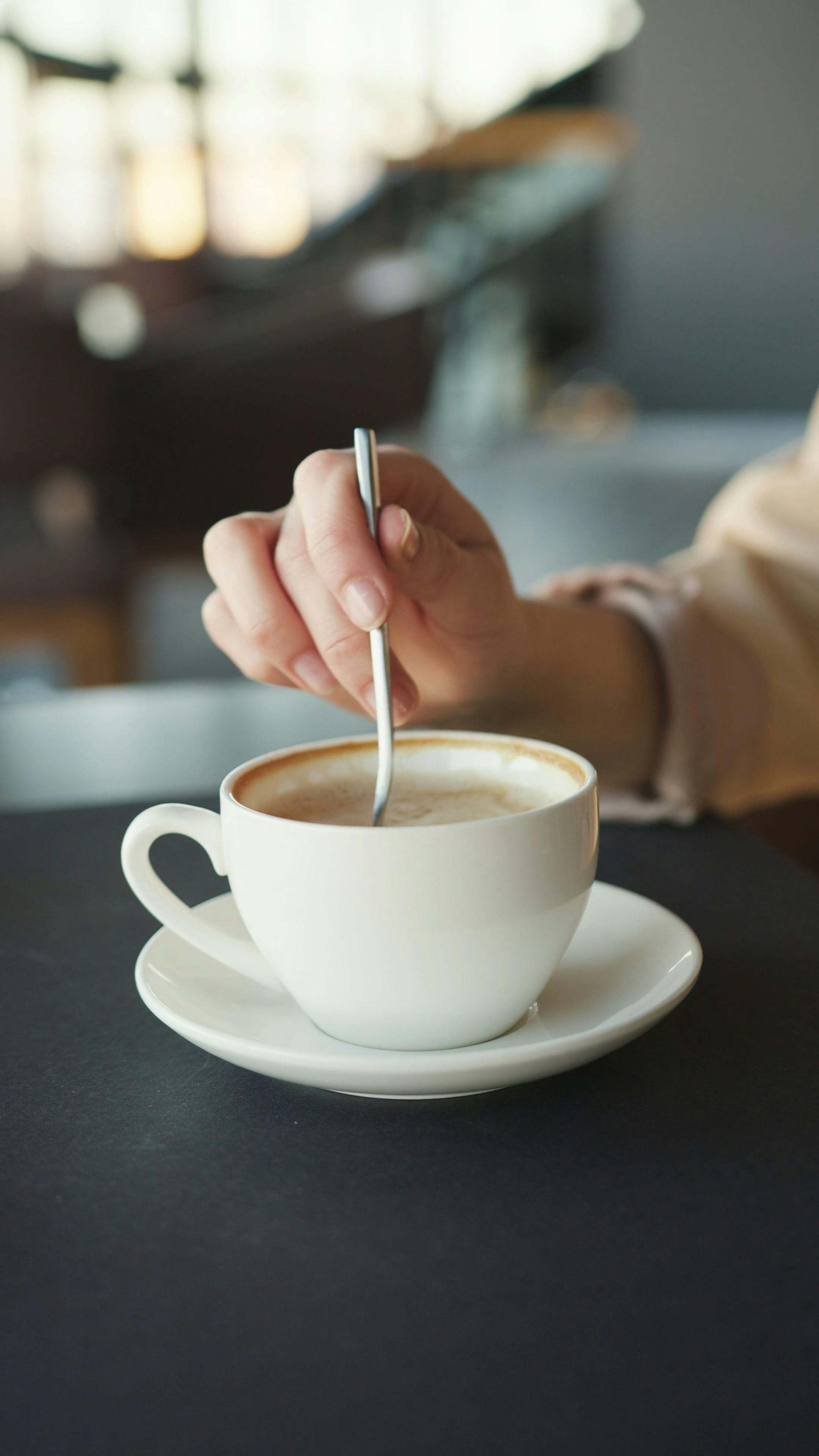 A Person Stirring a Cup of Coffee · Free Stock Video