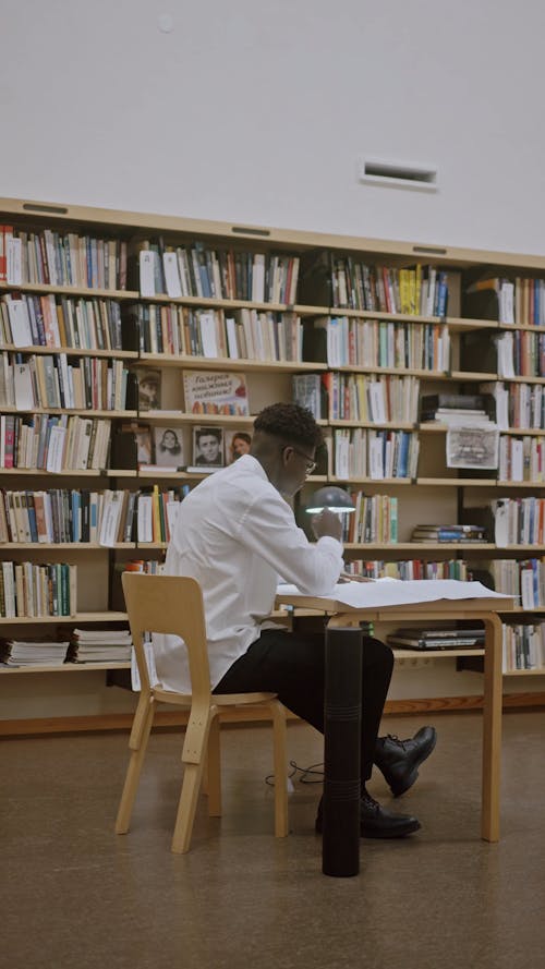 Man Drafting Inside of a Library