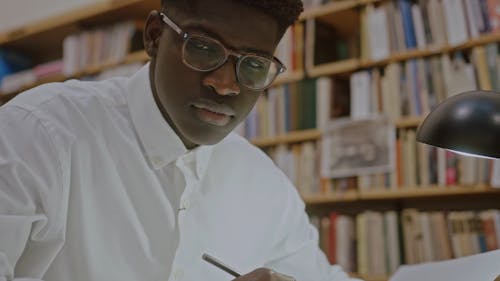 Young Man Reading at Library