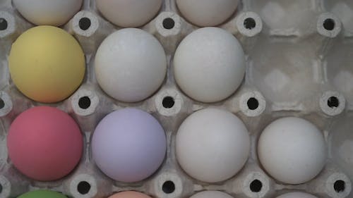 View of Colorful Eggs and Cracked Eggs in a Tray