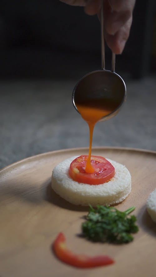 Egg Yolk Being Dumped Over Gourmet Dish