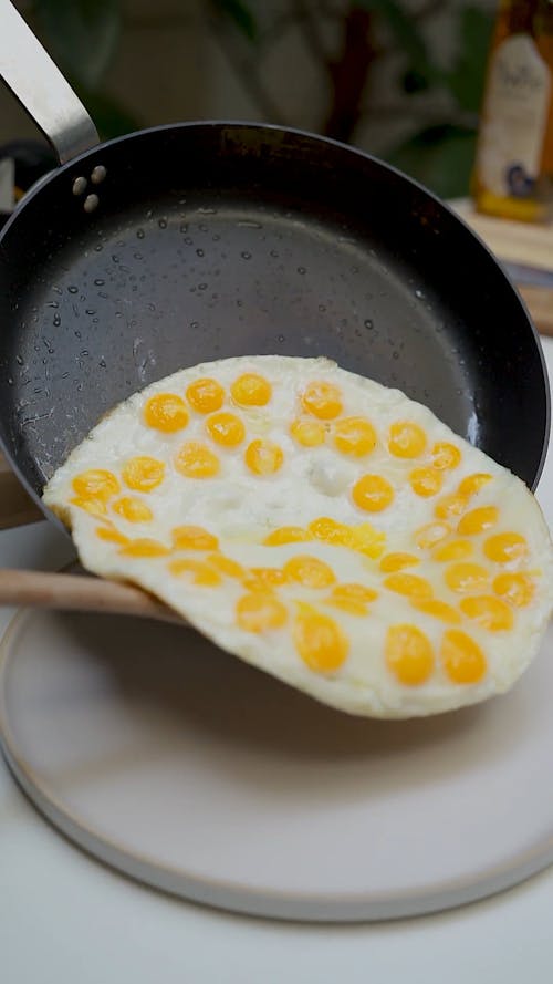 Fried Eggs Being Transferred To Plate