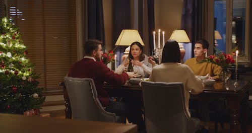 Friends Toasting On Dining Table