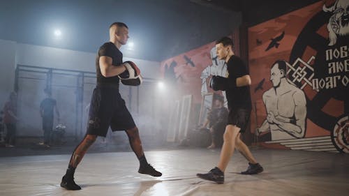 A Man Hitting Focus Mitts