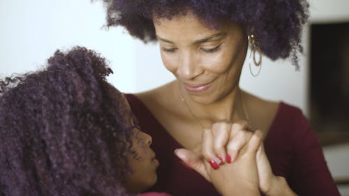 Mother And Daughter Showing Affection For Each Other