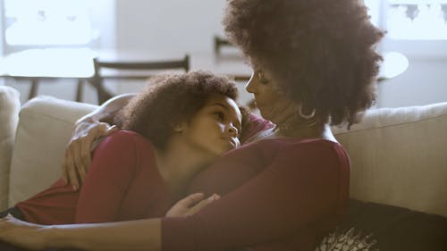 Mother And Child Sitting On The Sofa