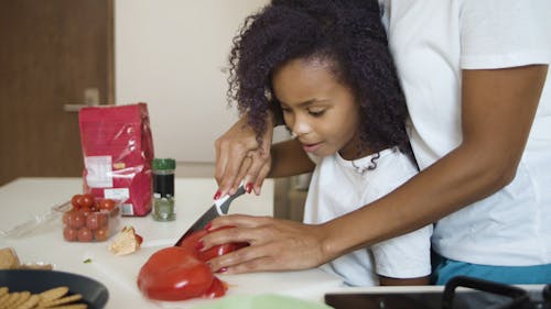 Mom Teaching Daughter in the Kitchen