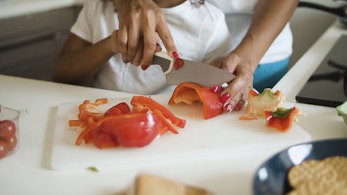 Person Slicing A Vegetable