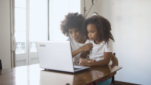 Mother And Daughter In Front Of A Laptop