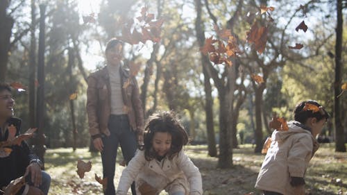 Family Playing with the Autumn Leaves 