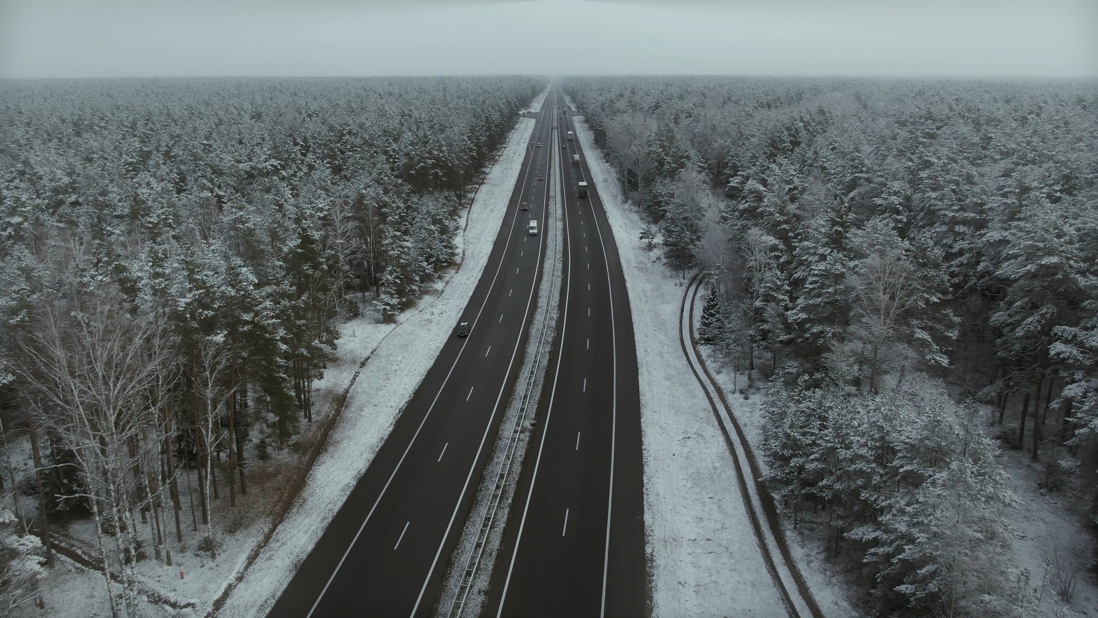 Drone Footage of a Road in the Middle of a Snowy Forest Free Stock ...