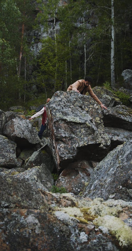 Couple Standing On Rock While Admiring Landscape