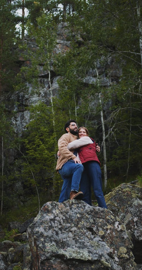 Couple Hugging Each Other While Standing On Rock