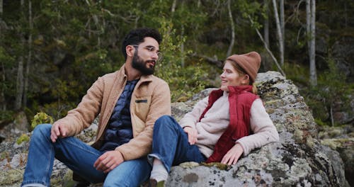 Couple Chilling Out On Rock Formation 