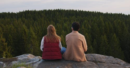 Romantic Couple Sitting on Hilltop