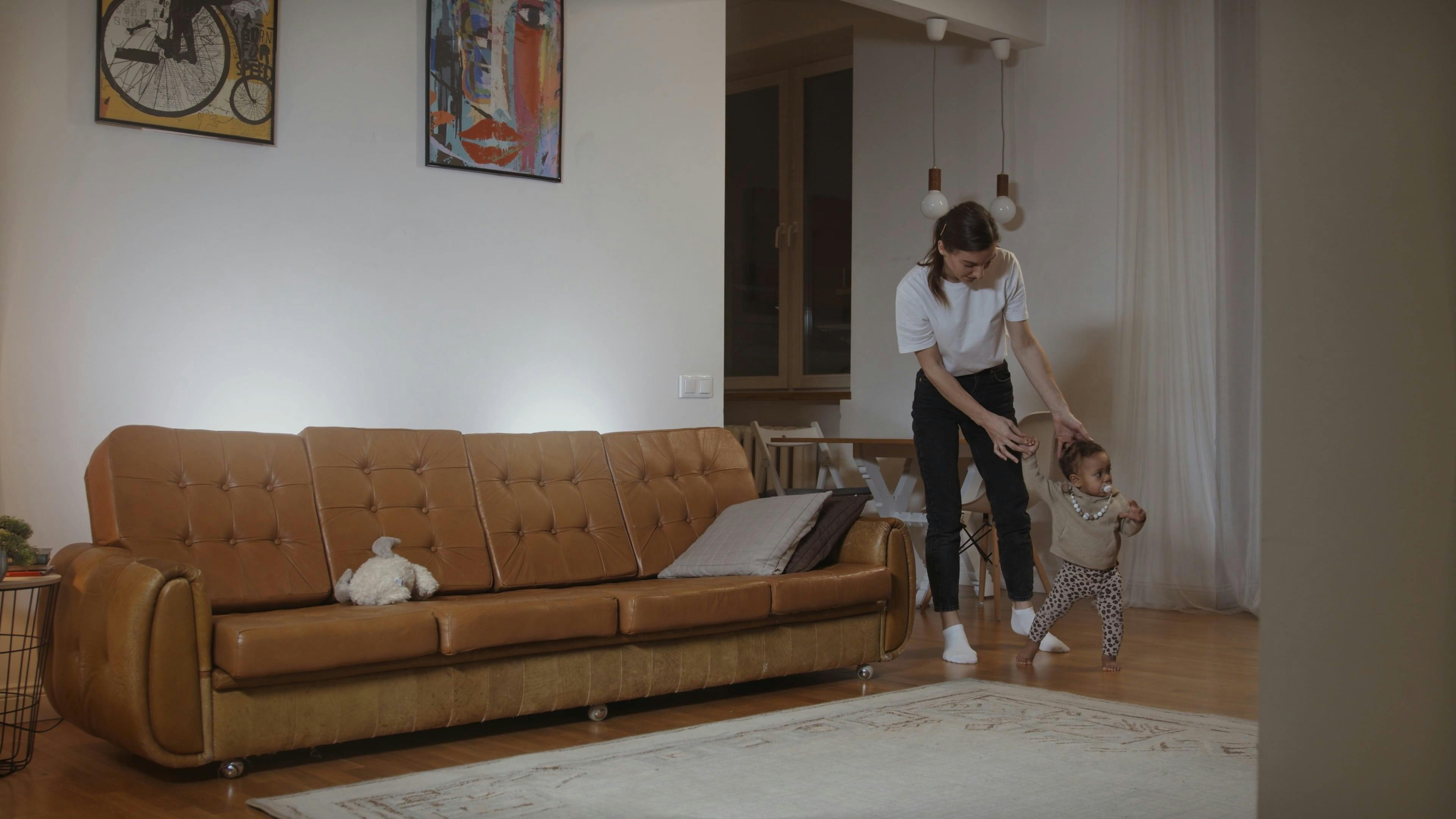 Adult and Toddler Walking in Living Room · Free Stock Video