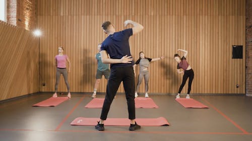 Gym Instructor Leading the Warm-up Exercise 