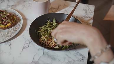 cutting and eating the food using bread knife and fork