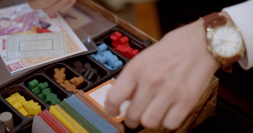 Person Arranging Cards in Board Games 