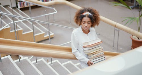 A Young Woman Carrying Books