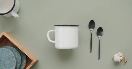 A Mug Beside a Tespoons