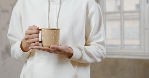 A Person Holding the Mug